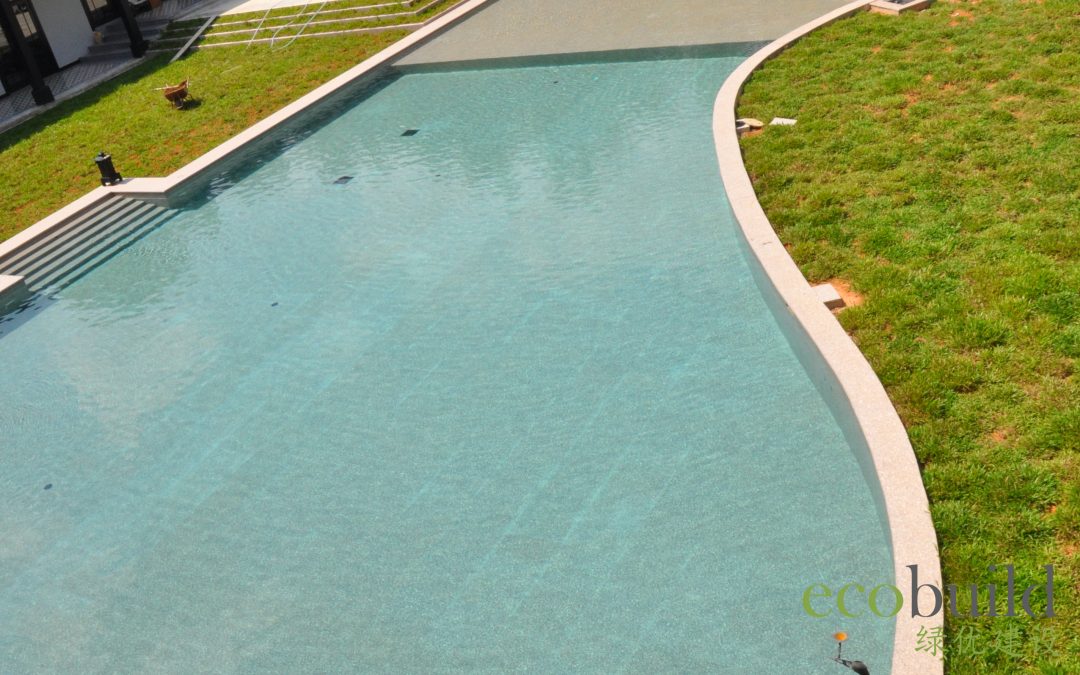 A lagoon size and beautifully shaped swimming pool in a luxurious bungalow